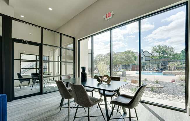 a dining room with a table and chairs in front of a large window