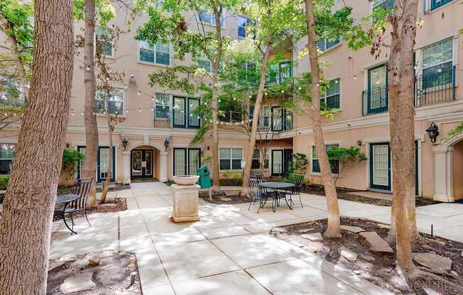 A courtyard with a fountain in the middle of it.
