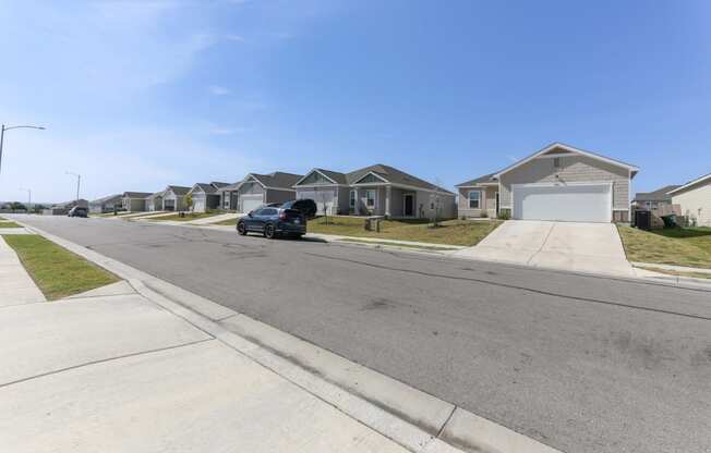 Side view of the driveway looking toward the Dogwood home floor plan type at Beacon at Presidential Heights in Manor, TX