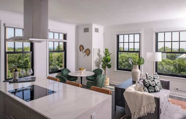a kitchen with a white counter top and a living room  at The Belden Stratford, Chicago, Illinois