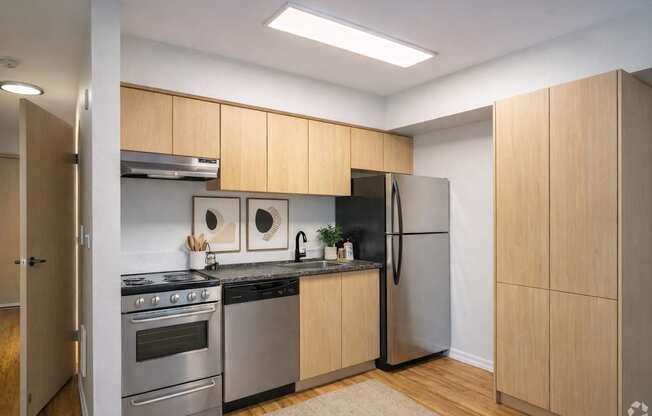 A kitchen with wooden cabinets and stainless steel appliances.