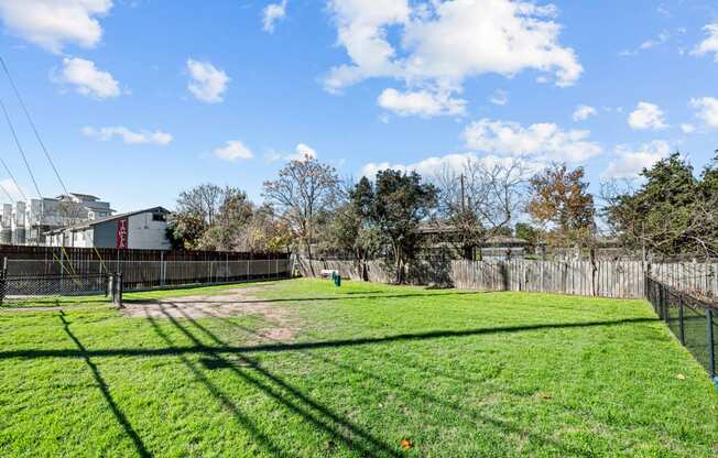 the backyard of a house with a yard and a fence