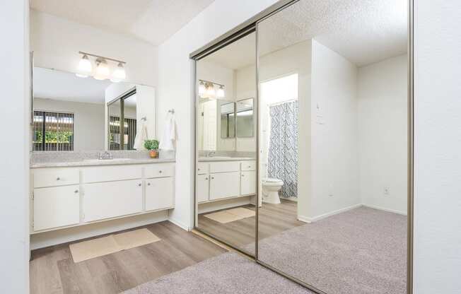 Bathroom sink and large mirror and closet at Woodbend, Alta Loma, CA, 91701