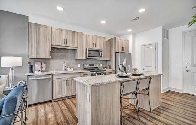 A modern kitchen with wooden cabinets and a central island.