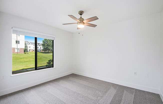 Spacious bedroom with large window at The Crossings Apartments, Grand Rapids, Michigan