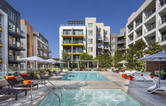 a rendering of a pool in front of an apartment building