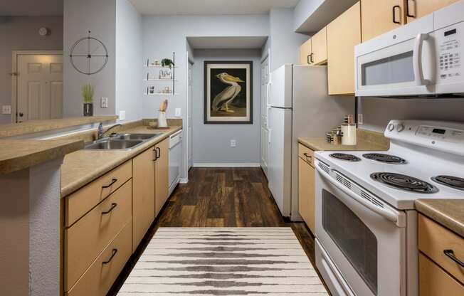 a kitchen with white appliances and wooden cabinets