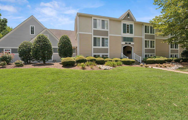 A large building with a lawn in front of it.
