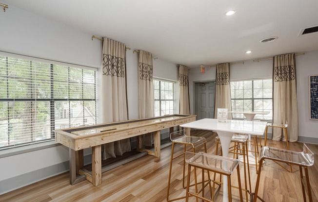 a kitchen with a bar and a table with chairs