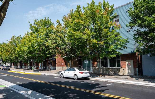 a white car parked in front of a building on a street