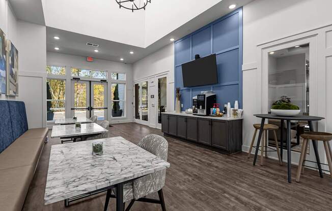 A modern dining room with a marble table and chairs.