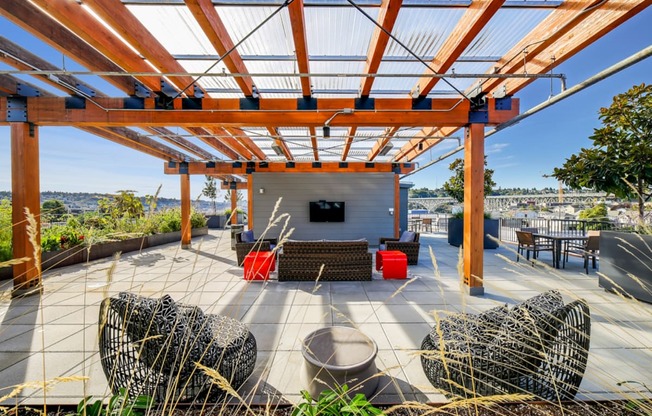 a covered patio with furniture and a television at The Hayes on Stone Way, Washington