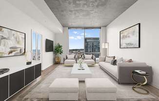 A modern living room with a large window and a view of the city.