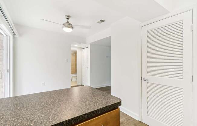 a kitchen with a counter top and a door to a hallway