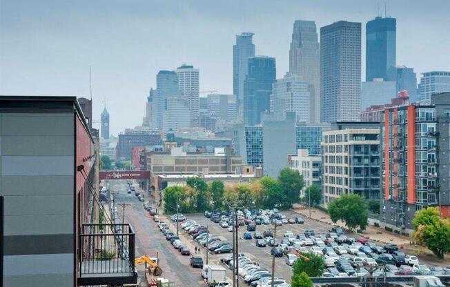 A city street with cars and buildings in the background.