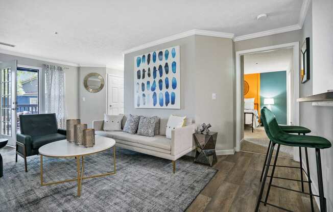 Living room with couch, chair and bar stools.