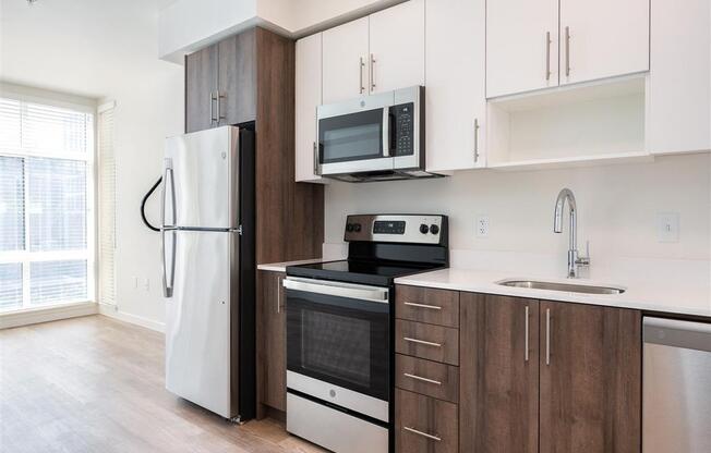 a kitchen with white cabinets and a stove and refrigerator