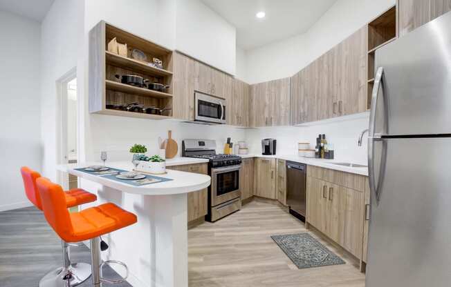Kitchen with stainless steel appliances and bar stools