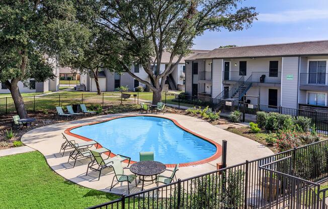 a house with a pool in front of a building