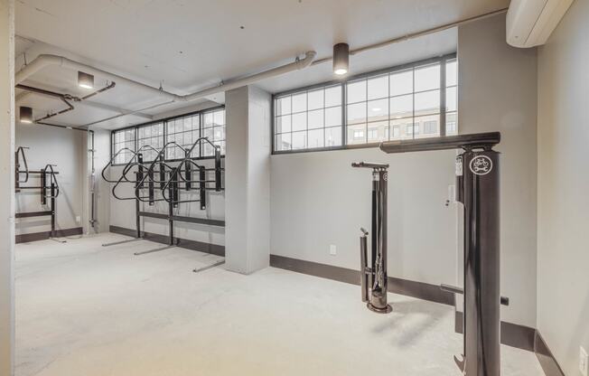 the interior of a building with white walls and gym equipment