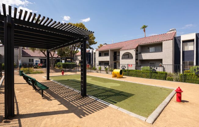 a picnic area with a red fire hydrant and green grass