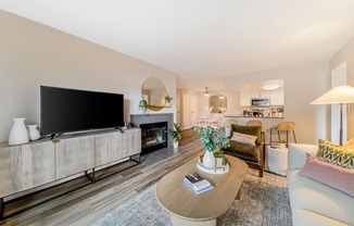 a living room with a large tv and a fireplace  at Citrine Hills, Ontario