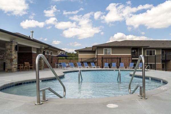 Resort-style pool with shallow soaking area at The Villas at Falling Waters townhomes for rent in west Omaha NE