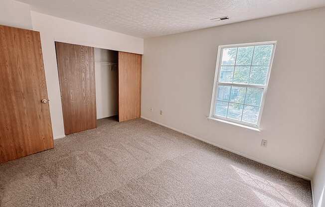 an empty room with a door and a window