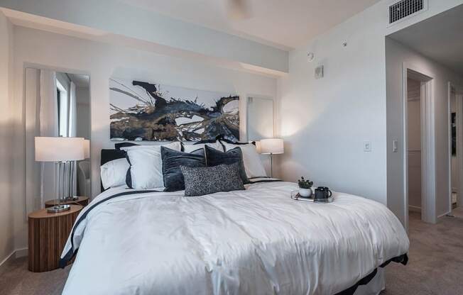a bedroom with a large bed and a large window at Altis Santa Barbara, Naples, Florida