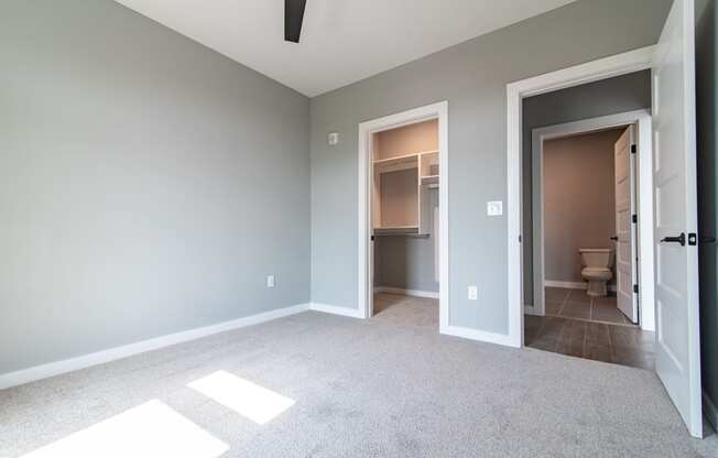 an empty bedroom and bathroom in a new home