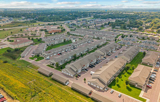 A bird's eye view of a residential area with houses and cars.