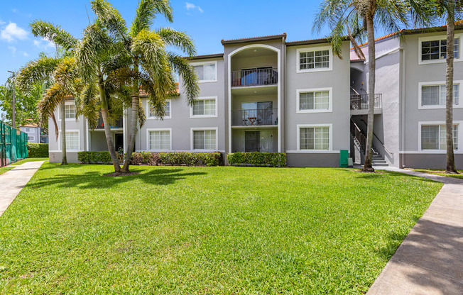 A building with a green lawn in front of it.