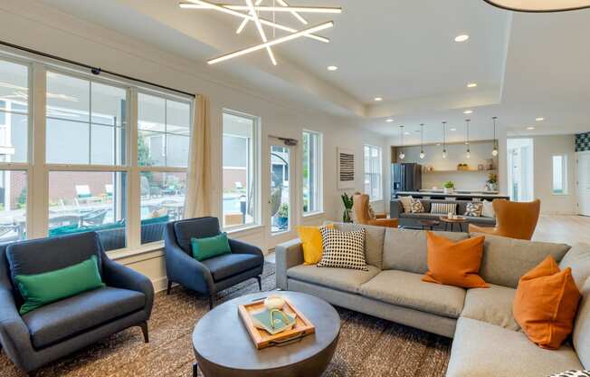 a living room filled with furniture and a large window