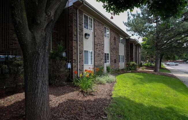 side view of the building with a lawn and trees at Village Club of Rochester Hills, Shelby Township Michigan