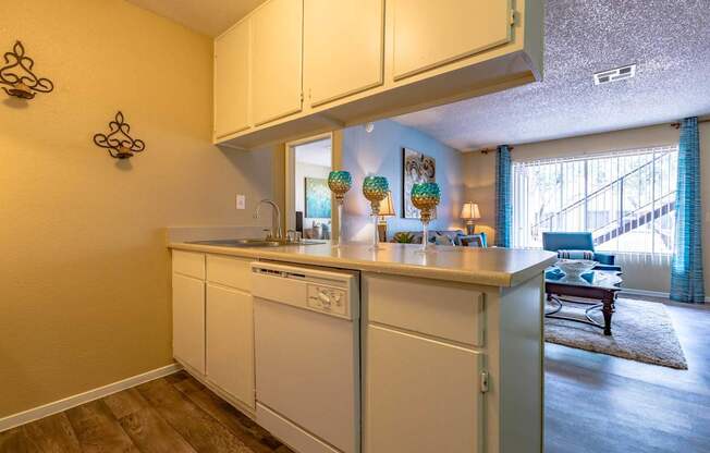 A kitchen with white cabinets and a countertop.