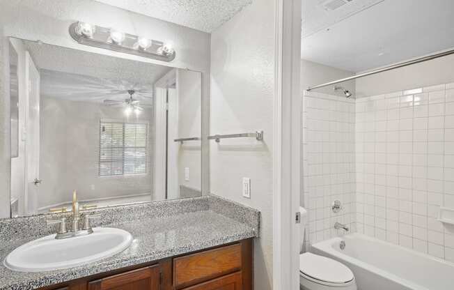 a bathroom with a sink toilet and tub