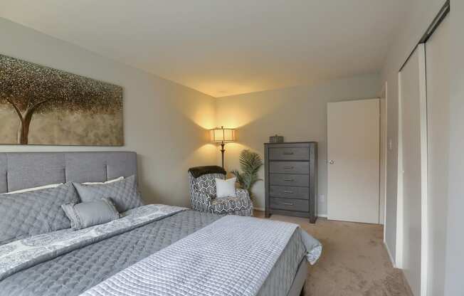 Mechanicsburg Apartments | Delbrook Manor Apartments | a bedroom with a large bed and a dresser