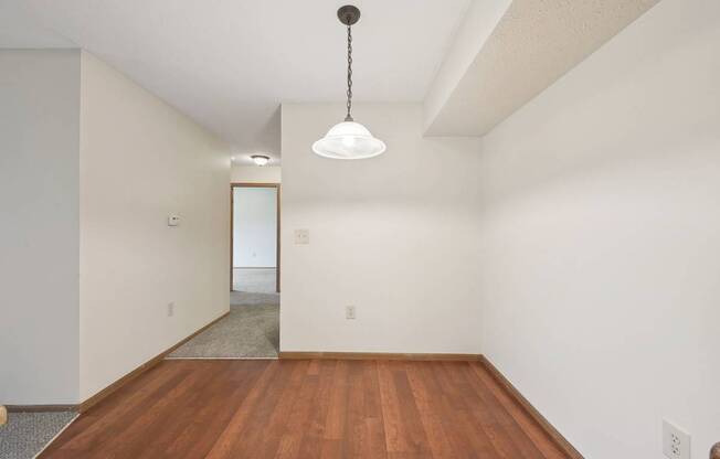 A room with a wooden floor and a white ceiling.