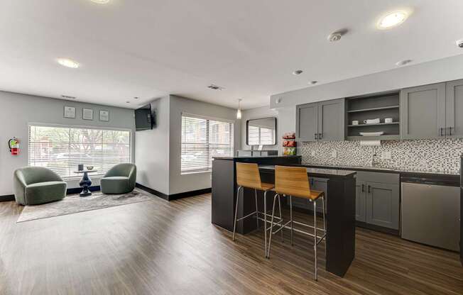 A modern kitchen with a bar stool and a chair.