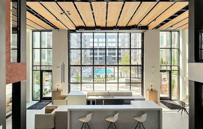 Impressive multi-story clubhouse with glass garage-style doors that open to outside