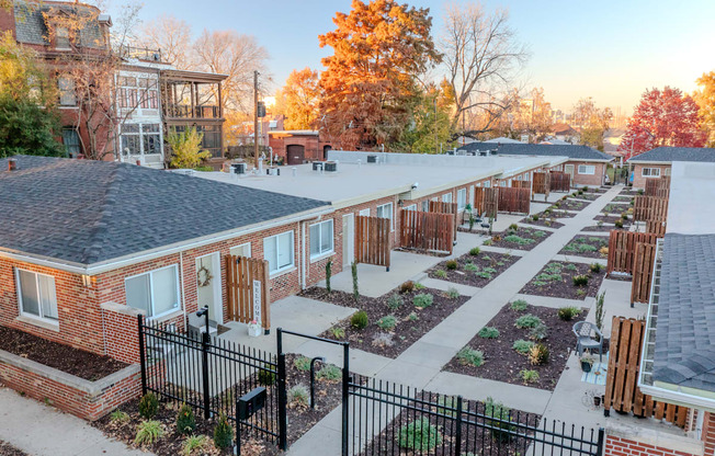 an aerial view of a community garden with brick buildings