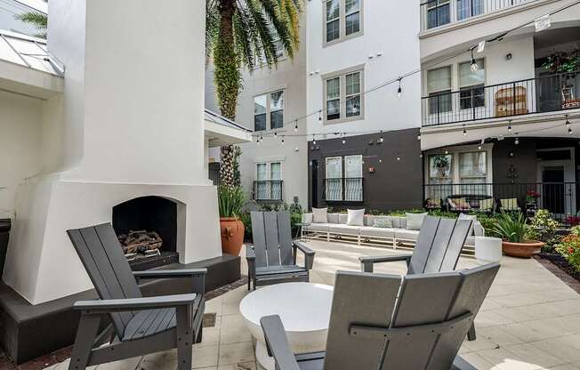 A patio with chairs and a fireplace.
