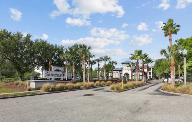 A street view of a Sarasota sign with palm trees on the side.