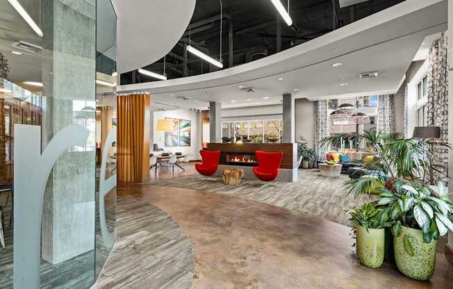 the lobby of an office with a fireplace and plants