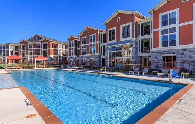 a house with a pool in front of a building