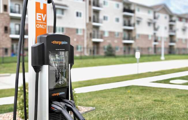 an electric charger in front of an apartment building