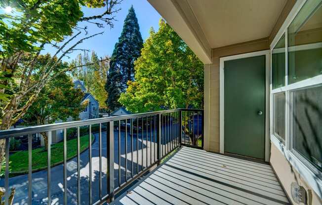 the view from the balcony of a home with a balcony railings and a door