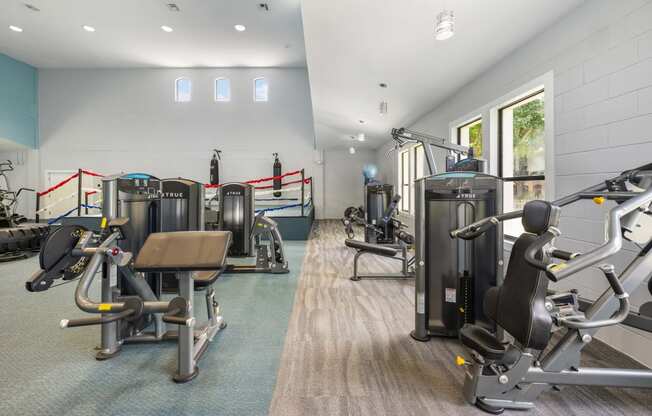 a gym with cardio equipment and weights in a building