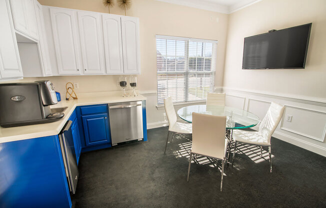 A kitchen with blue cabinets and white walls.