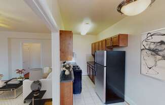 living area with sofa, coffee table and view of kitchen at the klingle apartments in washignton dc